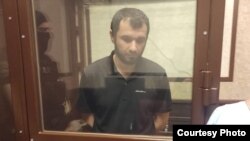 Kishukov in an enclosure in a Russian courtroom