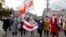 Belarusian pensioners carrying banned white-red-white flags and flowers parade through the streets of Minsk during a rally to demand the resignation of authoritarian leader Alyaksandr Lukashenka and a new fair election on October 19.