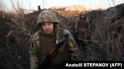 UKRAINE - Ukrainian soldiers walk along tranches on their position on the front line with Russia backed separatists in Donetsk region, February 21, 2022
