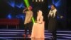 Afghan singer Zulala Hashemi (center) performs alongside competitors Sayed Jamal Mubarez (left) and Babak Mohammadi during the television music competition Afghan Star on March 9.