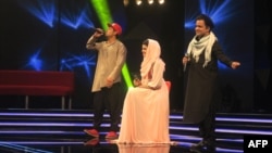 Afghan singer Zulala Hashemi (center) performs alongside competitors Sayed Jamal Mubarez (left) and Babak Mohammadi during the television music competition Afghan Star on March 9.