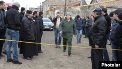 Armenia - A senior Russian army officer approaches a house in Gyumri where 6 people were killed by a gunman who Armenian police believe was one of his soldiers, 12Jan2015.