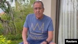 Russian Foreign Minister Sergei Lavrov reads documents on a patio in Bali in a video distributed on November 14.