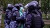 Police officers detain a demonstrator during a protest against the mobilization in Moscow on September 24.