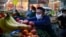 Kazakhstan - A vendor arranges fruits and vegetables at a market in Almaty on April 25, 2020, amid the coronavirus pandemic. (Photo by Ruslan PRYANIKOV / AFP)