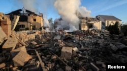 Firefighters work at the site of a Russian missile strike in Kharkiv on May 10.