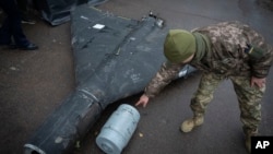 Український офіцер демонструє термобаричний заряд збитого безпілотника «Шахед», запущеного Росією. 14 листопада 2024 року