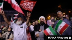 Pro-government demonstrators in Tehran celebrate Iran’s June 13 air strike on Israel. While such scenes are genuine, RFE/RL has found that Iranian state media has also circulated unrelated or outdated visuals to support its narrative of the conflict.