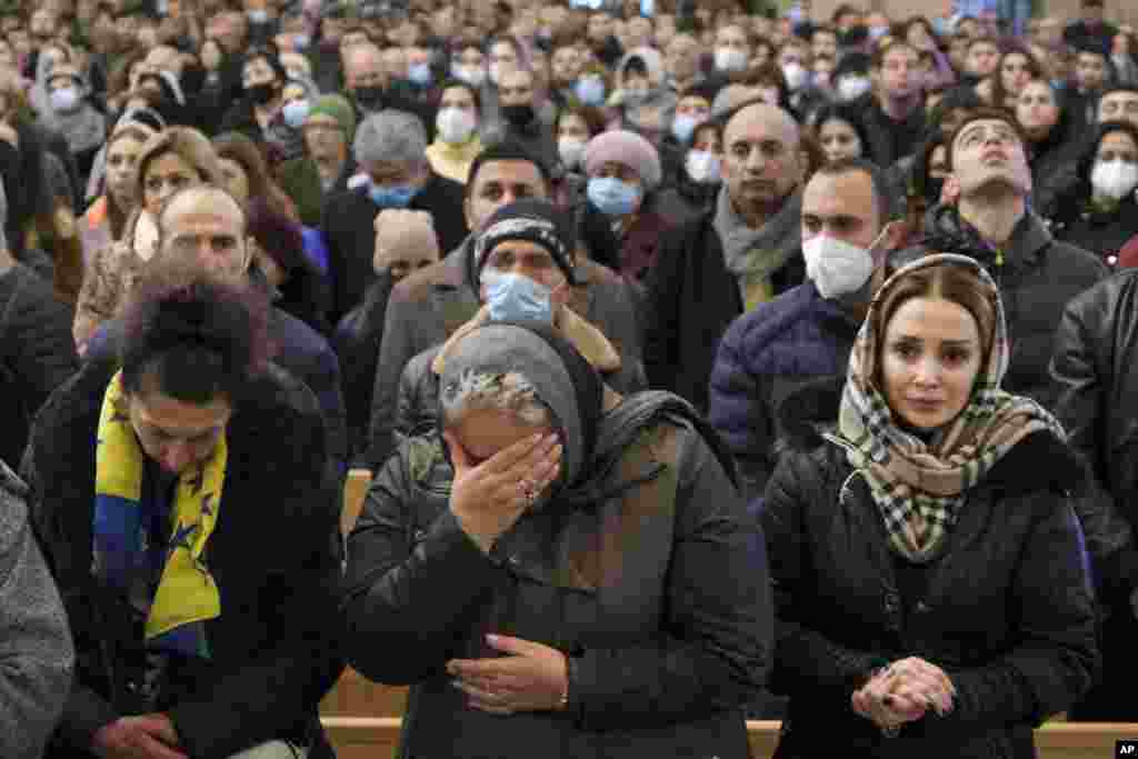 Women weep during a church service held in Yerevan on December 19.&nbsp;