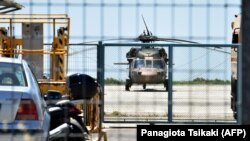 A Turkish military helicopter lands in the northern Greek city of Alexandroupolis with eight men on board who have requested political asylum after the attempted coup in Turkey, July 16, 2016. 