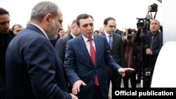 Armenia - Businessman Davit Ghazarian (C) shows Prime Minister Nikol Pashinian around a newly built dairy factory of his Spayka company, Yerevan, March 26, 2019.