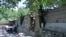 Members of the Afghan security forces take their positions during an ongoing clash between Taliban and Afghan forces in Mihtarlam, the capital of Laghman Province, on May 24.