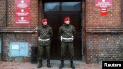 Poland -- Military police stand guard outside the military prosecutor's office in Poznan, 09Jan2012