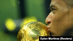 Кіліан Мбаппе цілує Кубок світу після перемоги збірної Франції на чемпіонаті світу, Москва, 15 липня 2018 року