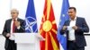 SDSM leader Zoran Zaev (right) and BDI leader Ali Ahmeti announce that they have reached a deal for forming a new government in Skopje on August 18.