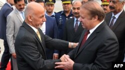 Pakistan Prime Minister Nawaz Sharif (right) greets Afghan President Ashraf Ghani upon his arrival in Rawalpindi on December 9.