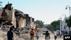 Haiti - Locals walk in a destroyed street in Port-au-Prince, on January 14, 2010, following the devastating earthquake that rocked Haiti on January 12