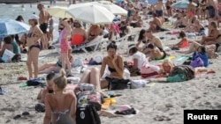 People on a beach in Odesa on August 10.