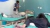 Afghan men receive treatment at a hospital after suicide bombers and gunmen attacked a provincial Afghan police headquarters in Gardez on October 17.