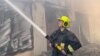 An image provided by Ukraine's emergency services shows a firefighter working at storage facilities that were hit during Russian missile and drone strikes on Odesa on July 19. 