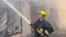 An image provided by Ukraine's emergency services shows a firefighter working at storage facilities that were hit during Russian missile and drone strikes on Odesa on July 19. 