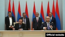 Armenia -- The ruling Republican Party and Armenian Revolutionary Federation sing a power-sharing agreement, Yerevan, 24Feb2016.