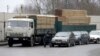 A Russian border guard walks past waiting cars at a border crossing with Lithuania in Kybartai. 