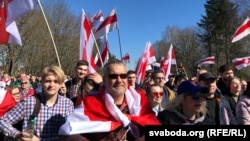 People gathered in a local park for the event, singing patriotic songs and waving flags of the Belarusian People’s Republic.