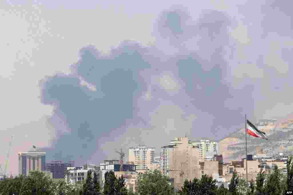 Smoke billows for the second day from the Shahran oil depot, northwest of Tehran, on June 16, 2025.