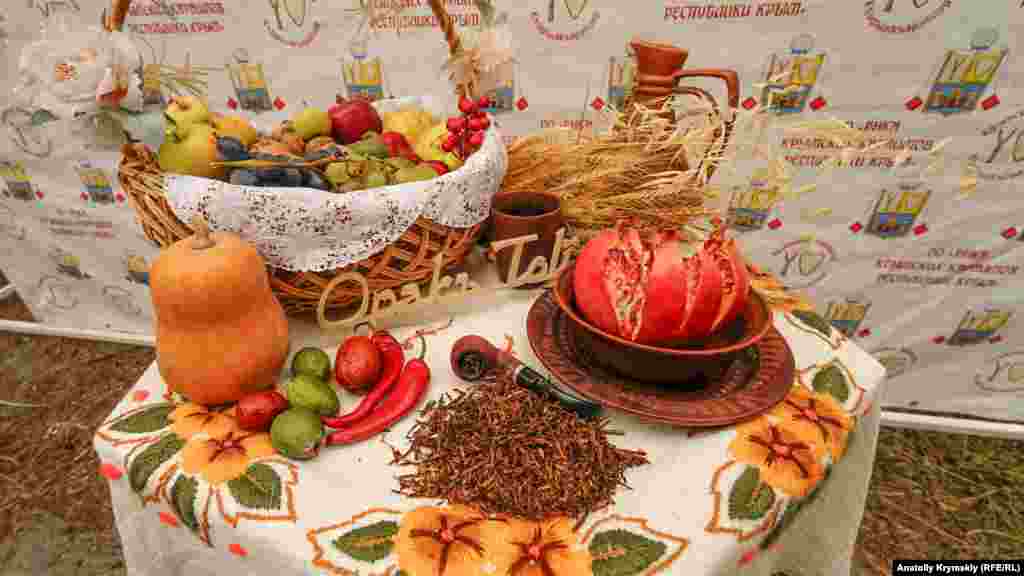 Oraq Toyunıñ timsali olğan küz bereketi. Ortada - tütün