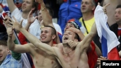 Russian soccer fans celebrating during their country's 4-1 win over the Czech Republic in Wroclaw, Poland. 