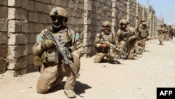 Afghan National Army commandos take up positions during a military operation in Helmand Province.