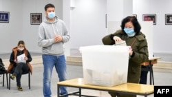 A woman casts her vote in Mostar's municipal elections on December 20.