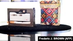 A Soviet KGB spy cigarette pack with a hidden camera is displayed during an auction preview at Julien's Auctions in Beverly Hills, California.