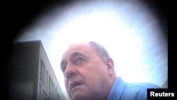 David Ballantyne Smith meets with "Irina," an MI5 officer posing as a member of Russia's military intelligence service, on August 9, 2021, in this still image taken from a covert camera video played in court in London on February 13.