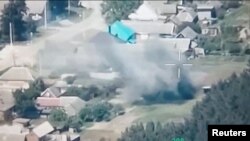 A still image from a drone footage released by the Free Russia Legion shows what appears to be an explosion near the Novaya Tavolzhanka settlement in Russia's Belgorod region on June 1. 