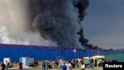 Plumes of smoke rise from the blaze at the Ozon warehouse near Istra, a village about 40 kilometers northwest of Moscow.
