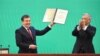 Shavkat Mirziyaev (left) is sworn as Uzbek president at a joint session of the parliament's two chambers in Tashkent on December 14. 