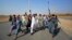 Afghans shout slogans against the government after a military operation reportedly left many civilians dead in the Rodat district of Nangarhar Province on October 24.