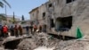 Israeli soldiers and first responders check the damage caused to a building from an Iranian strike in Beit She'an on June 21, 2025. (Photo by Jalaa Marey / AFP)