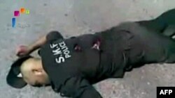 جسد یکی از نیروهای پلیس در جسرالشغور که حکومت سوریه می‌گوید به دست شورشیان این کشور کشته شده‌اند