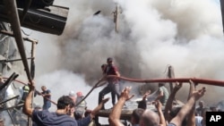 Спасатели и волонтеры проводят поисково-спасательные работы на месте взрыва в ТЦ «Сурмалу», 14 августа 2022 г.