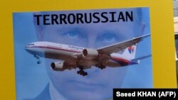 Плакат учасників акції протесту в столиці Австралії у липні 2014 року