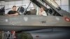 Ukrainian President Volodymyr Zelenskiy (left) and Danish Prime Minister Mette Frederiksen sit in a F-16 fighter jet in the hangar of the Skrydstrup Airbase in Vojens, northern Denmark, on August 20.