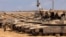 Israeli army soldiers stand atop main battle tanks deployed at a position along the border with the Gaza Strip and southern Israel on July 29, 2025.