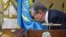 Kazakhstan - Acting President of Kazakhstan Kassym-Jomart Tokayev kisses a flag as he takes part in a swearing-in ceremony during a joint session of the houses of parliament in Astana, Kazakhstan March 20, 2019. Kazakh Presidential Press Service/Handout v