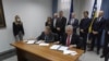 Political leaders Bakir Izetbegovic (left) and Dragan Covic sign the agreement in Mostar on June 17. 