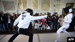 International Olympic Committee President Thomas Bach (left) and Russian fencing's two-time Olympic champion, Karina Aznavuryan, give a fencing master class in Moscow in 2015.