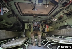 A Ukrainian serviceman inside the troop compartment of a Bradley in September 2023.