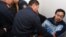 Полицейские уводят оппозиционного активиста Ермека Нарымбаева из зала суда. Алматы, 14 мая 2010 года.